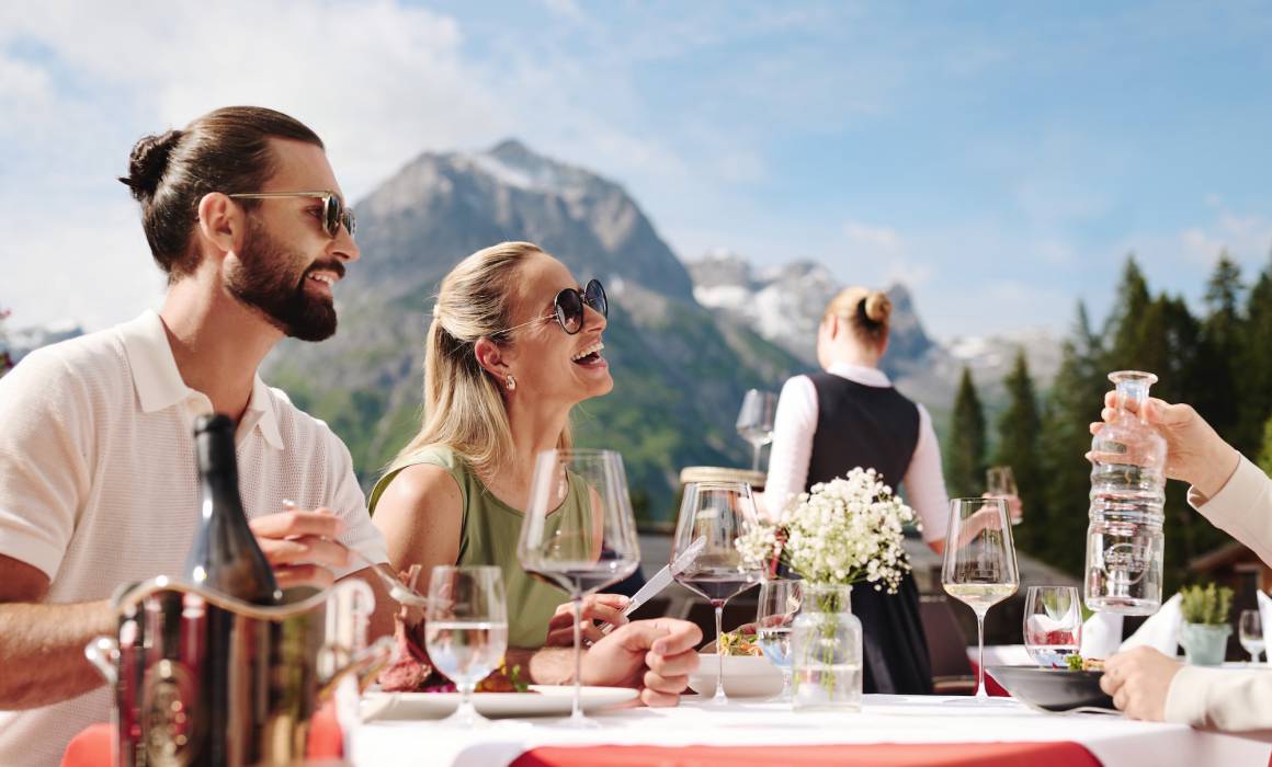 Guests enjoying lunch on the sun terrace with panoramic views
