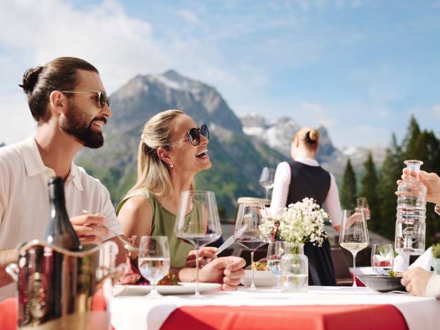 Guests enjoying lunch on the sun terrace with panoramic views
