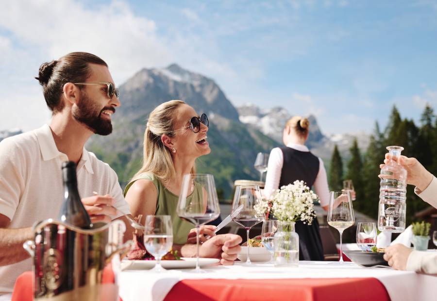 Guests enjoying lunch on the sun terrace with panoramic views